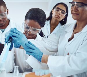 Scientist, teacher or learning students and dropper in healthcare study, medical research or future medicine study. Smile, happy men or women in science laboratory and university education professor.
